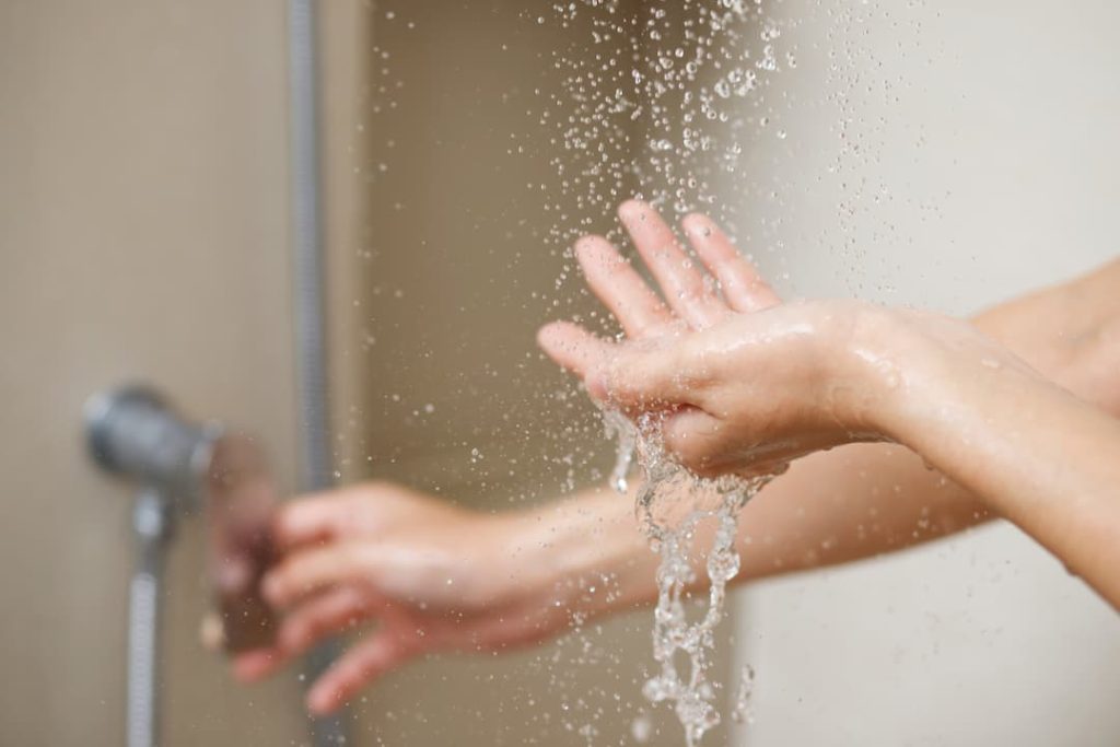 Person turning on shower